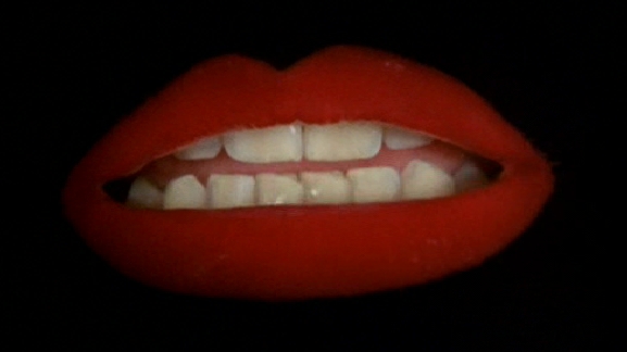 Let's start off easy: Whose lips are shown during the opening number, 